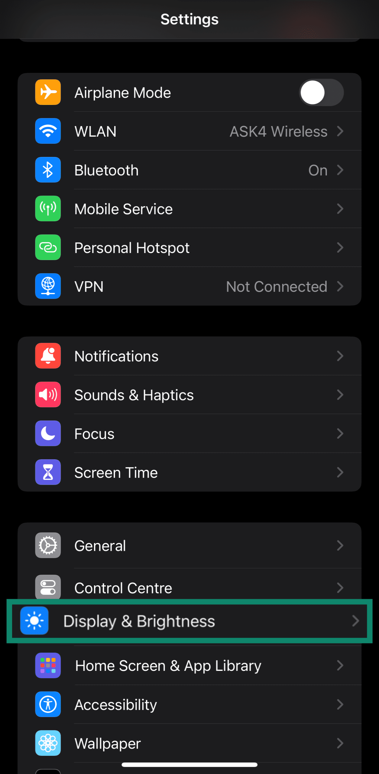 Accessing the Display & Brightness settings through an iPhone's settings menu
